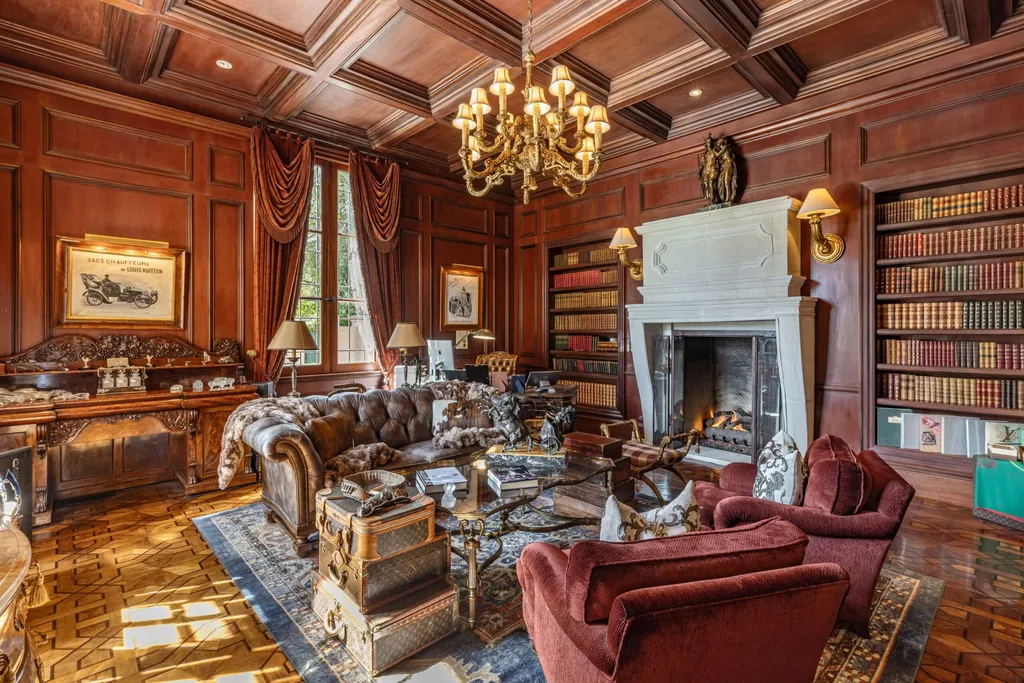 A $68,000,000 Beverly Park Estate Signals a New Era of Ultra-Scale Luxury in Los Angeles 10 Private library and home office inside a Beverly Park estate in Los Angeles featuring wood-paneled walls, built-in bookshelves, fireplace, and luxury furnishings