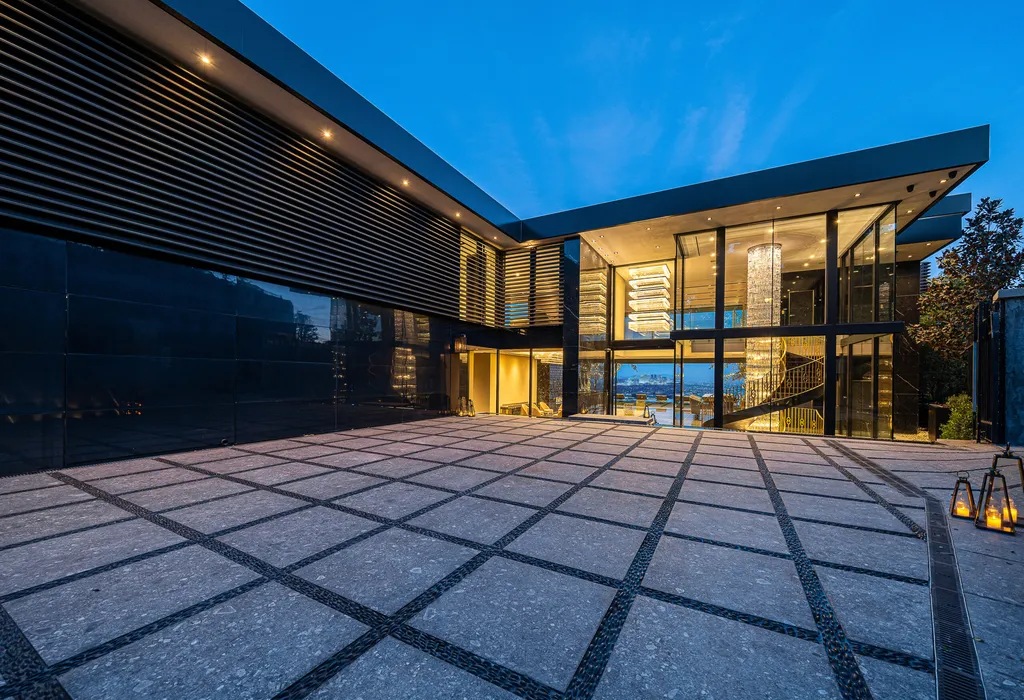 Most Expensive Homes in California 18 La Fin Bel Air mansion grand entrance with glass facade and multi level chandelier