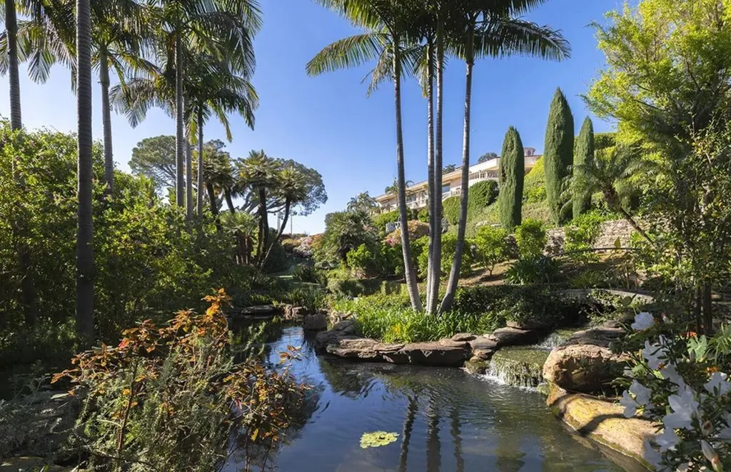Most Expensive Homes in California 23 luxury estate garden with pond, palm trees, and landscaped greenery in Bel Air