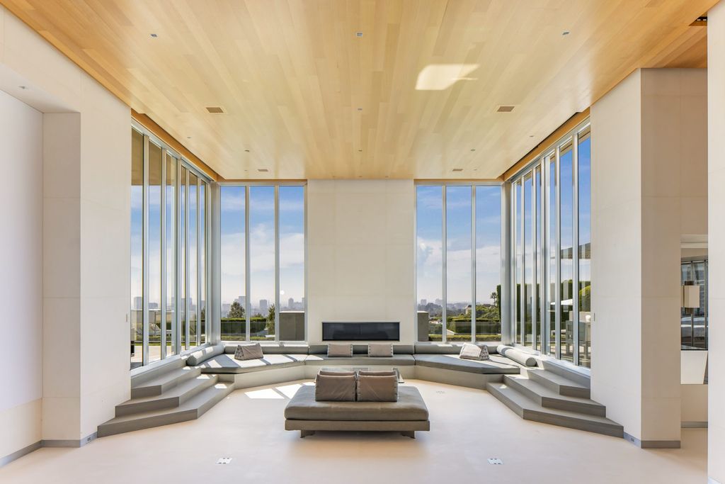 Most Expensive Homes in California 5 modern living room with floor to ceiling glass walls overlooking Los Angeles skyline