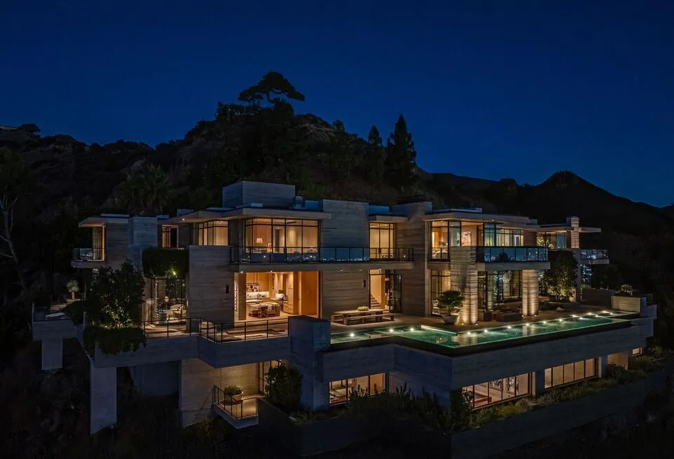 Most Expensive Homes in California 11 Hollywood Hills luxury mansion illuminated at night with multi level terraces