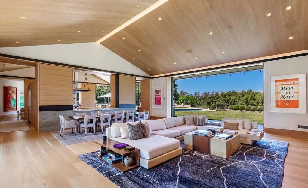 Most Expensive Homes in California 33 open plan living room with sliding glass walls connecting indoor and outdoor spaces