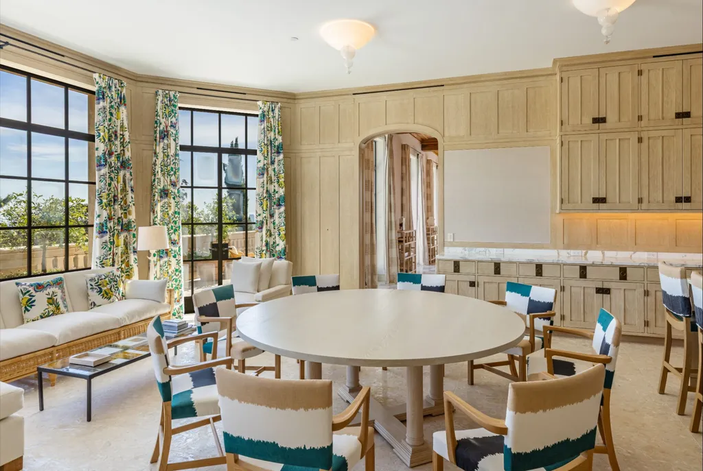 A Bel Air Estate That Redefines the Upper Limits of Global Luxury 7 informal dining area at Chalon Road estate in Bel Air with round table, natural light, and garden views