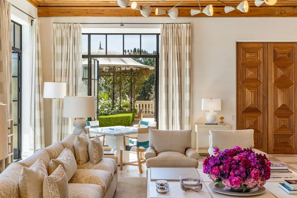 A Bel Air Estate That Redefines the Upper Limits of Global Luxury 5 indoor living space at Chalon Road estate in Bel Air opening to terrace and landscaped gardens with seamless indoor outdoor flow