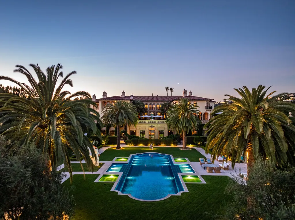 A Bel Air Estate That Redefines the Upper Limits of Global Luxury 2 rear view of Chalon Road estate in Bel Air featuring formal gardens, illuminated pool, and expansive luxury residence at dusk