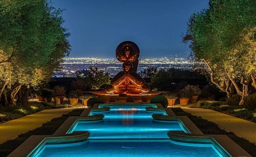A Bel Air Estate That Redefines the Upper Limits of Global Luxury 13 sculpture and illuminated water feature at Chalon Road estate in Bel Air with panoramic Los Angeles city lights at night