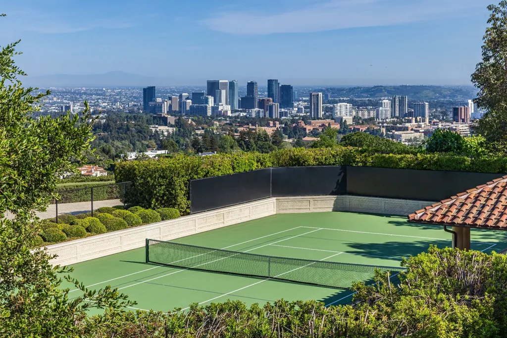 A Bel Air Estate That Redefines the Upper Limits of Global Luxury 12 private tennis court at Chalon Road estate in Bel Air overlooking Los Angeles skyline and surrounding hills