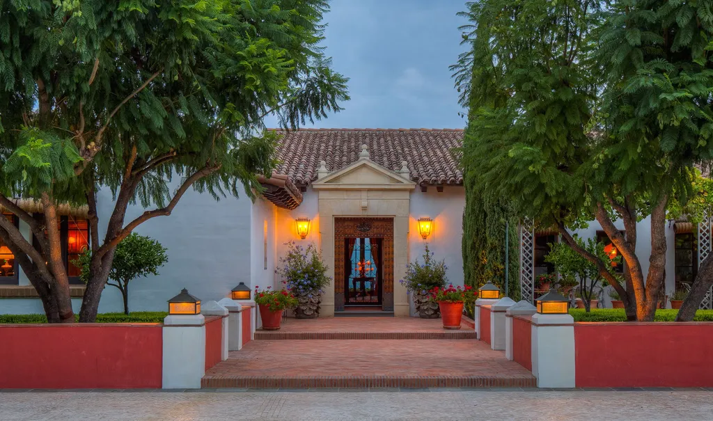Hacienda de la Paz: One of the Largest Private Estates in California 7 Hacienda de la Paz garden entrance with landscaped pathway traditional Spanish facade and evening lighting