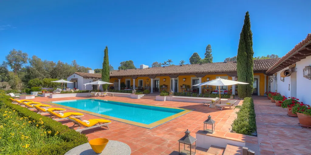 Hacienda de la Paz: One of the Largest Private Estates in California 6 Hacienda de la Paz outdoor pool courtyard with terracotta tiles landscaped gardens and Spanish style architecture