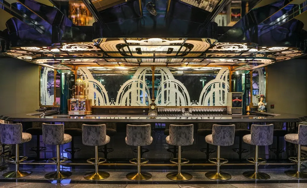 The Hearst Estate in Beverly Hills: A Historic Landmark Where Hollywood Legacy Meets Market Reality 12 The Hearst Estate in Beverly Hills featuring art deco nightclub bar with mirrored ceiling, illuminated details, and luxury seating