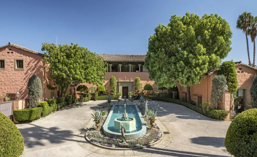 The Hearst Estate in Beverly Hills: A Historic Landmark Where Hollywood Legacy Meets Market Reality 3 The Hearst Estate in Beverly Hills featuring circular driveway with central fountain and landscaped Mediterranean courtyard