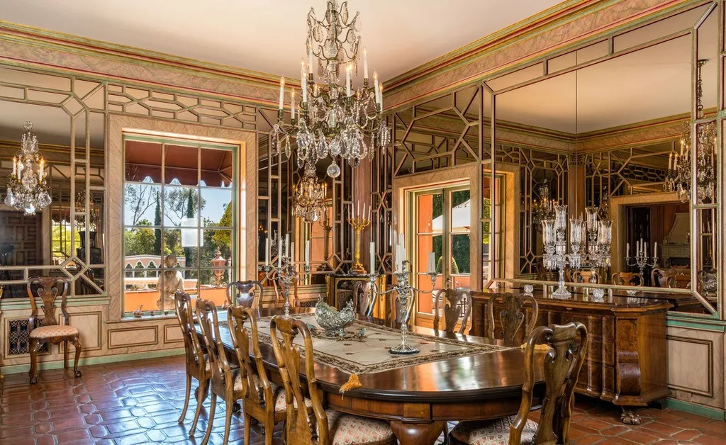 The Hearst Estate in Beverly Hills: A Historic Landmark Where Hollywood Legacy Meets Market Reality 7 The Hearst Estate in Beverly Hills featuring formal dining room with crystal chandelier, mirrored walls, and antique wood table