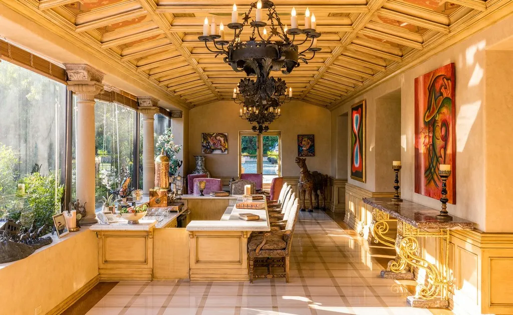 The Hearst Estate in Beverly Hills: A Historic Landmark Where Hollywood Legacy Meets Market Reality 8 The Hearst Estate in Beverly Hills featuring sunlit breakfast room with coffered ceiling, chandelier, and garden views