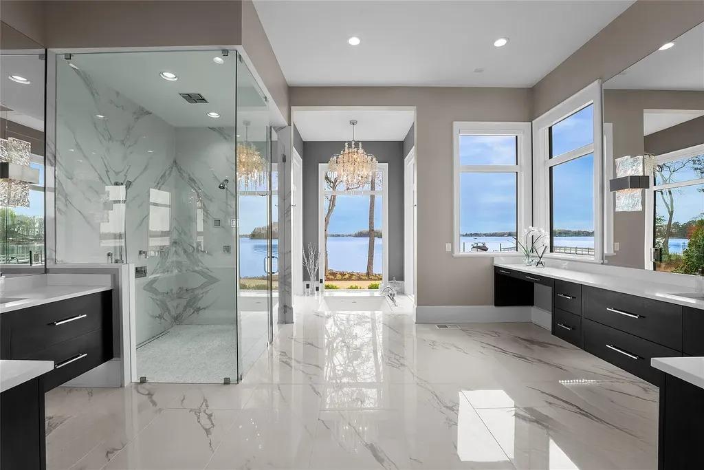 Lake Norman Estate Blends Architectural Precision With Private Waterfront Living 9 Luxury marble bathroom with glass shower and lake view in Lake Norman waterfront home