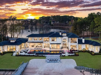 Lake Norman Estate Blends Architectural Precision With Private Waterfront Living 1 modern lakefront luxury home at sunset in Cornelius North Carolina overlooking Lake Norman with infinity pool
