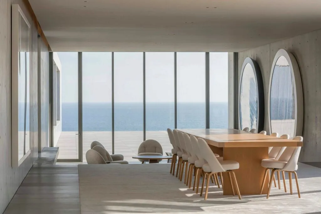 Most Expensive Homes Ever Sold in California 8 Minimalist dining room with floor to ceiling glass overlooking the Pacific Ocean in Malibu luxury estate