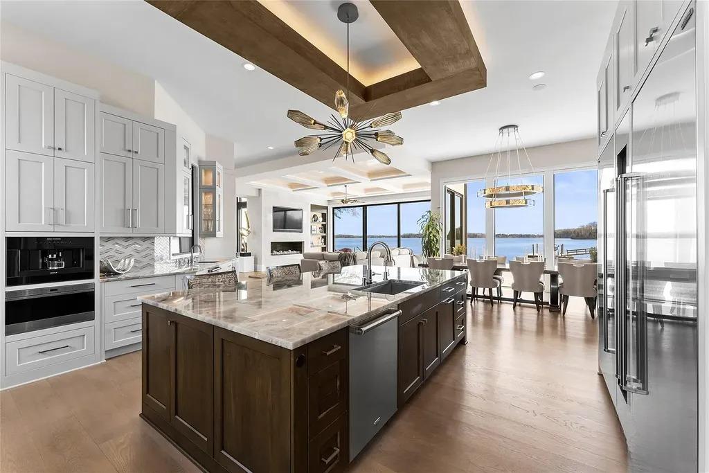 Lake Norman Estate Blends Architectural Precision With Private Waterfront Living 6 modern kitchen with large island and open plan layout overlooking Lake Norman in a luxury home in Cornelius North Carolina