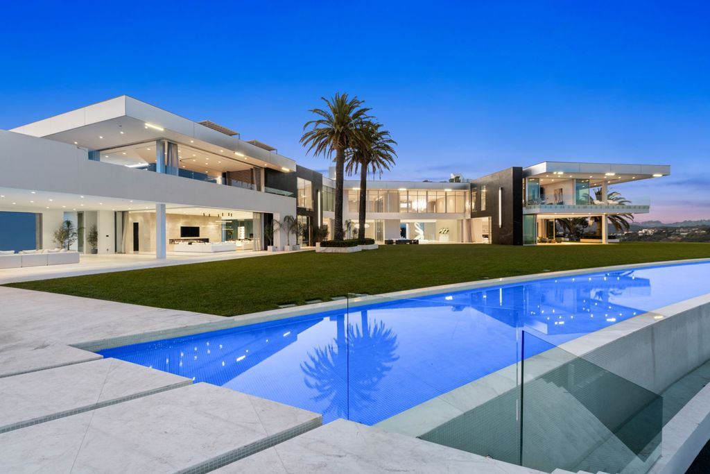 Most Expensive Homes Ever Sold in California 17 Night view of The One Bel Air luxury mansion with illuminated pool and modern architecture