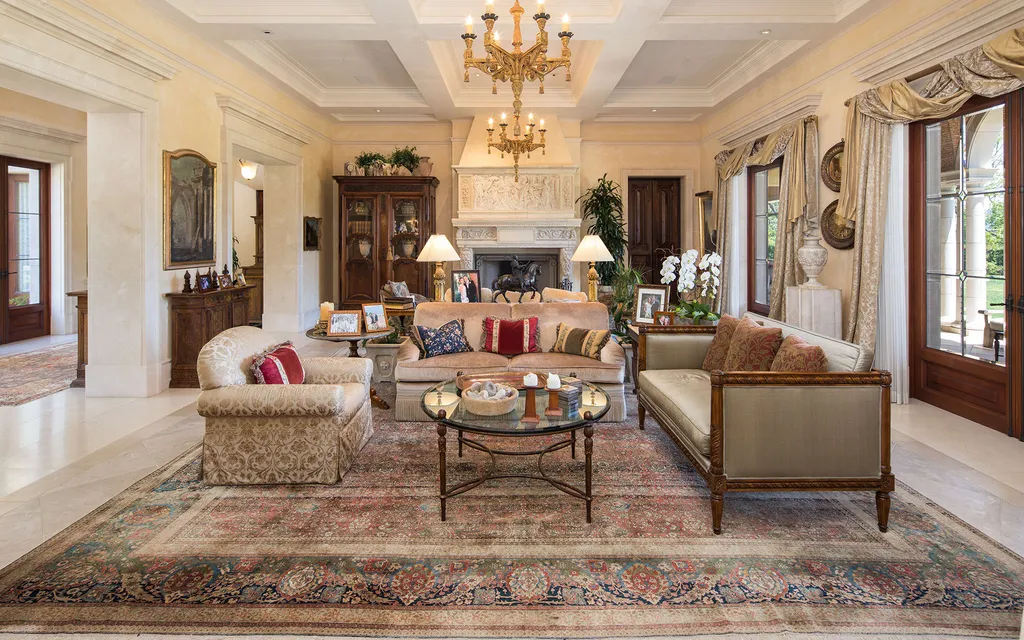 Villa Firenze: One of the Largest Private Estates in Beverly Hills 4 formal living room inside Villa Firenze Beverly Hills with fireplace chandelier and traditional furnishings