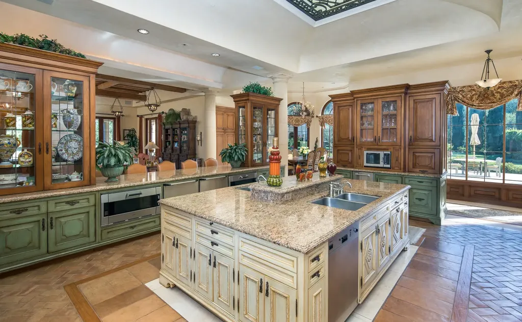 Villa Firenze: One of the Largest Private Estates in Beverly Hills 7 gourmet kitchen inside Villa Firenze Beverly Hills with large island cabinetry and garden access