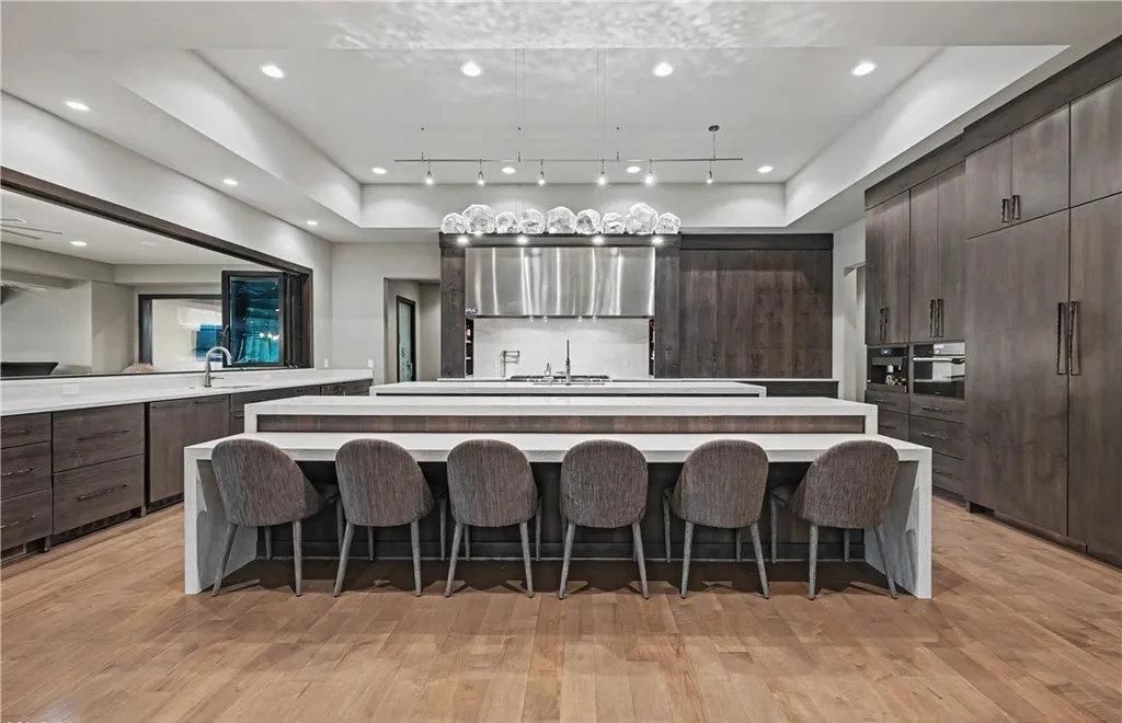 An Award Winning Modern Wellness Estate in Ohio Lists for $10,900,000 as a Private Resort Inspired Sanctuary 8 Modern luxury chef kitchen with oversized waterfall island at 1433 Ridgemont Trl in Hinckley Ohio