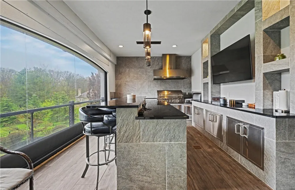 An Award Winning Modern Wellness Estate in Ohio Lists for $10,900,000 as a Private Resort Inspired Sanctuary 6 Luxury outdoor kitchen and covered entertaining terrace at 1433 Ridgemont Trl in Hinckley Ohio