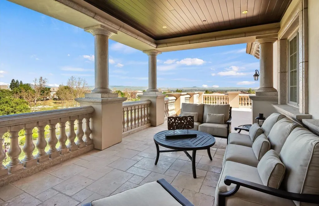 Inside a $13.5 Million Mediterranean Mansion in Ruby Hill, Pleasanton 12 Covered balcony at 1515 Germano Way overlooking the golf course and rolling hills of Pleasanton with Mediterranean stone columns and lounge seating.