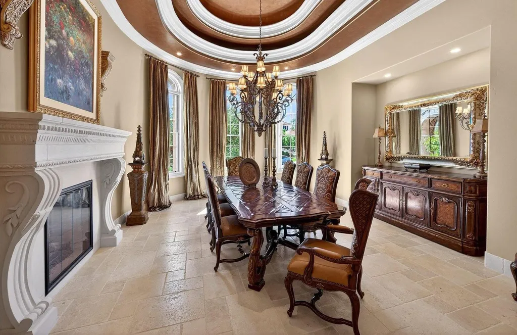 Inside a $13.5 Million Mediterranean Mansion in Ruby Hill, Pleasanton 5 Elegant formal dining room at 1515 Germano Way featuring a tray ceiling, chandelier, carved fireplace, and classic Mediterranean interiors.