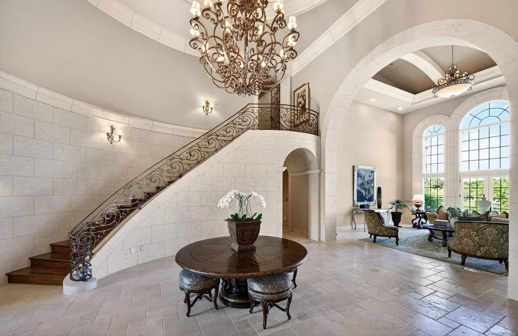 Inside a $13.5 Million Mediterranean Mansion in Ruby Hill, Pleasanton 3 Grand foyer inside 1515 Germano Way featuring a sweeping wrought-iron staircase, chandelier, arched stone architecture, and double-height ceilings.