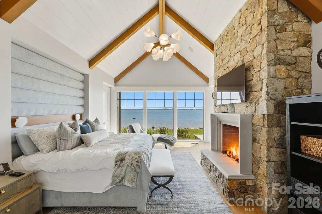 Lake Norman’s Ultimate Peninsula Estate Lists for $18,500,000 in Norman Estates 11 Lakefront primary bedroom suite with fireplace at 8515 Norman Estates Dr