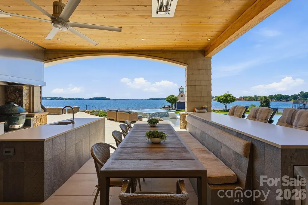 Lake Norman’s Ultimate Peninsula Estate Lists for $18,500,000 in Norman Estates 13 Luxury outdoor kitchen and dining terrace overlooking Lake Norman at 8515 Norman Estates Dr
