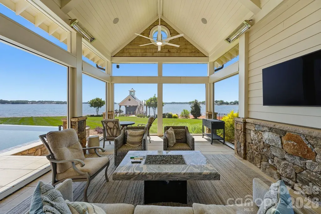 Lake Norman’s Ultimate Peninsula Estate Lists for $18,500,000 in Norman Estates 12 Screened outdoor lounge with Lake Norman views at 8515 Norman Estates Dr