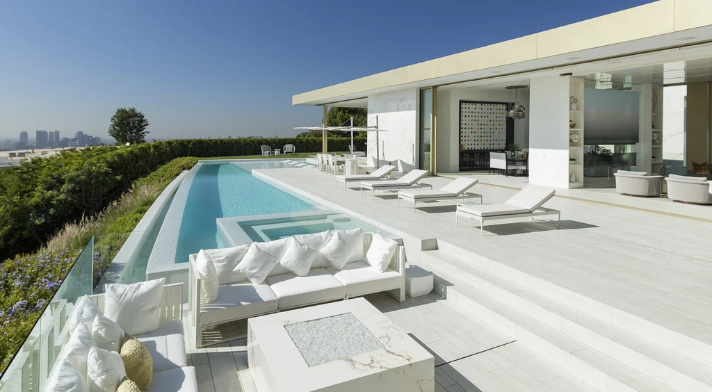 Modern Mansions in California: Where Design, Power, and Global Wealth Converge 9 luxury outdoor pool terrace at Opus Beverly Hills with open living space and city views