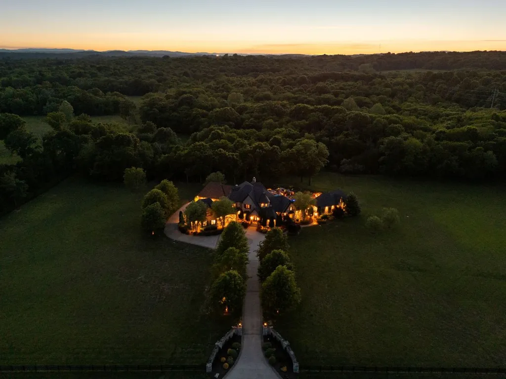 Inside a $12 Million Tennessee Estate With 62 Private Acres and Resort Amenities 10 Aerial sunset view of a private luxury estate in College Grove Tennessee surrounded by wooded acreage and expansive countryside
