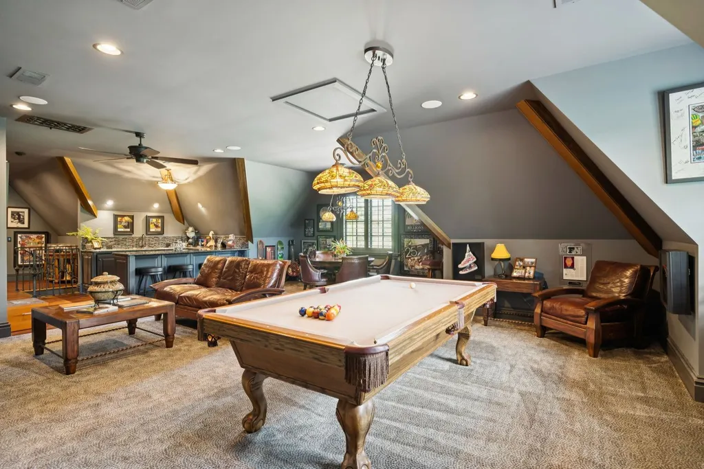 Inside a $12 Million Tennessee Estate With 62 Private Acres and Resort Amenities 7 Billiards and lounge room inside a luxury estate in College Grove Tennessee featuring a pool table, bar area, and casual entertainment space