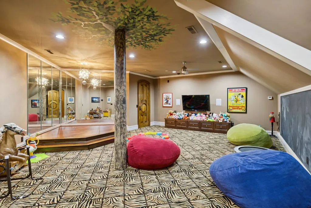Inside a $12 Million Tennessee Estate With 62 Private Acres and Resort Amenities 8 Children’s playroom inside a luxury estate in College Grove Tennessee featuring colorful seating, mirrored walls, and family recreation space