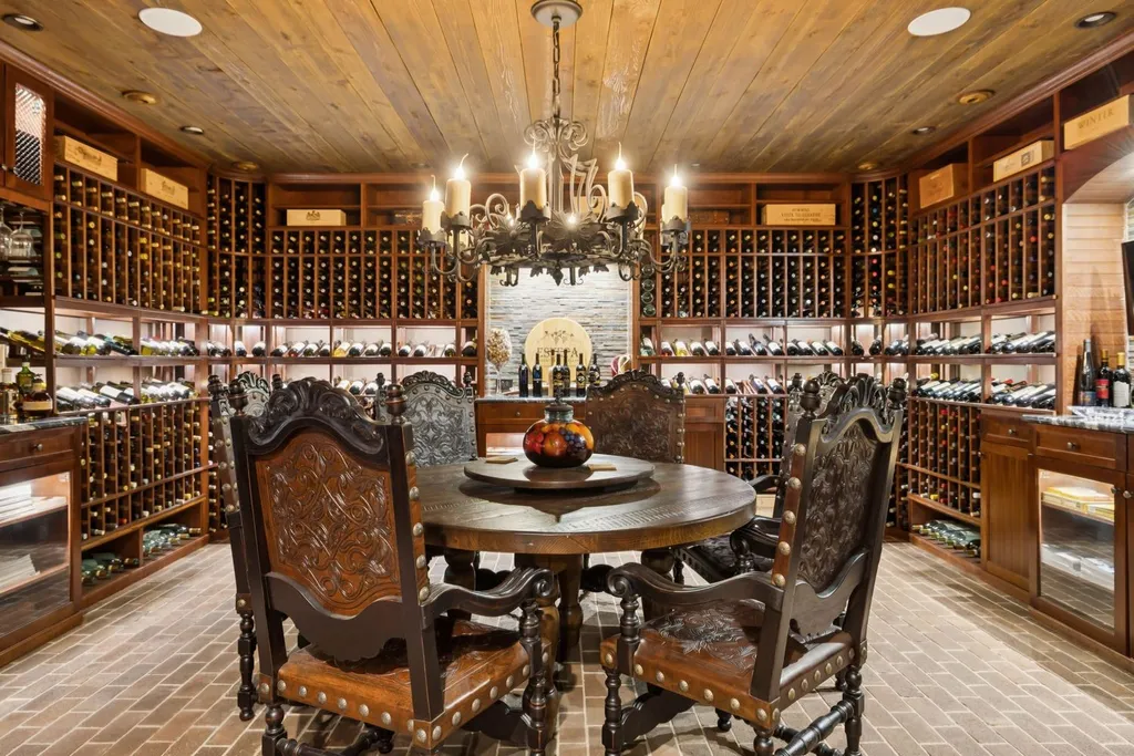 Inside a $12 Million Tennessee Estate With 62 Private Acres and Resort Amenities 6 Climate-controlled wine cellar inside a luxury estate in College Grove Tennessee featuring custom wood wine storage and tasting area
