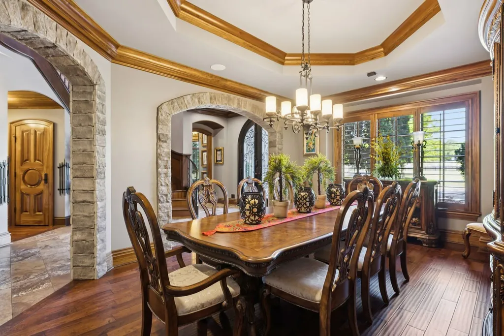 Inside a $12 Million Tennessee Estate With 62 Private Acres and Resort Amenities 12 Formal dining room inside a luxury estate in College Grove Tennessee featuring hardwood floors, stone archways, and traditional interior design