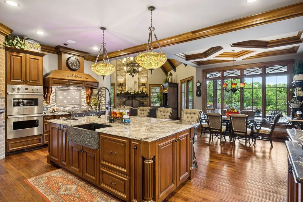 Inside a $12 Million Tennessee Estate With 62 Private Acres and Resort Amenities 11 Gourmet kitchen inside a luxury estate in College Grove Tennessee featuring custom cabinetry, large island, hardwood floors, and outdoor views