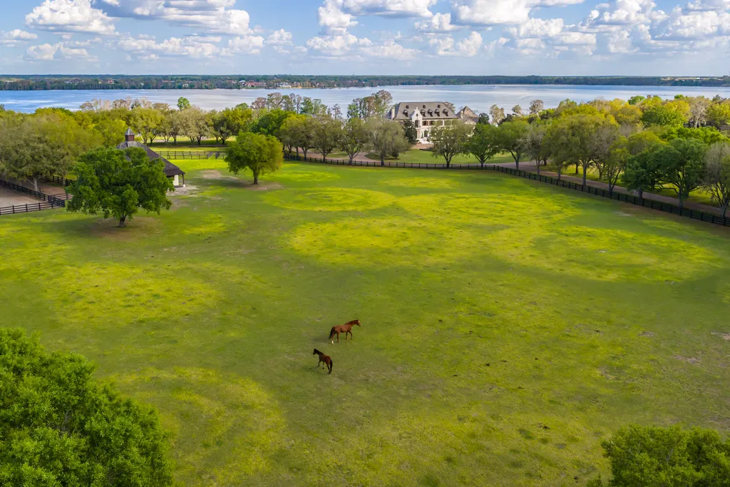 Inside Florida’s Most Ambitious Private Estate: The Oaks Emerges as a $115 Million Benchmark in Tampa Bay 15 Expansive equestrian grounds at The Oaks Estate with open fields and lake views in Tampa, Florida