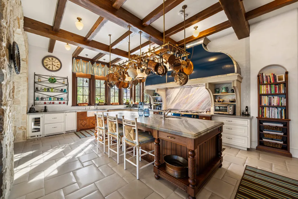 Inside Florida’s Most Ambitious Private Estate: The Oaks Emerges as a $115 Million Benchmark in Tampa Bay 5 Luxury kitchen at The Oaks Estate featuring custom cabinetry, large island, and hanging copper cookware in Tampa, Florida