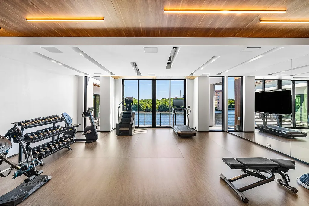 Boca Raton’s Trinity Point Estate Lists for $32.5 Million With 368 Feet of Intracoastal Frontage 12 Private waterfront fitness center at Trinity Point Estate featuring panoramic Intracoastal views and premium gym equipment