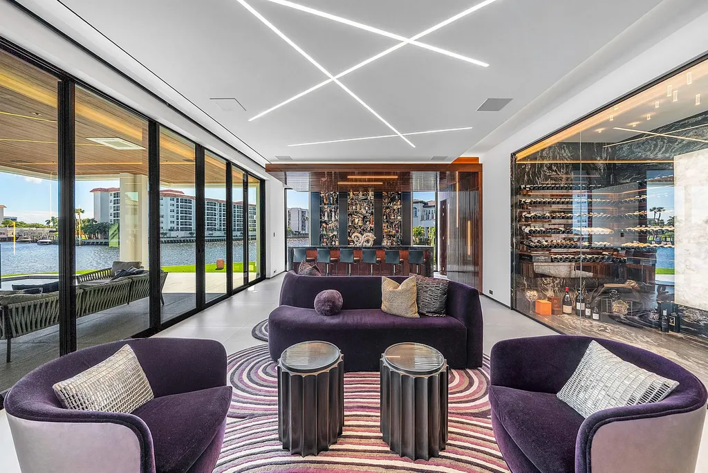 Boca Raton’s Trinity Point Estate Lists for $32.5 Million With 368 Feet of Intracoastal Frontage 11 Luxury wine lounge at Trinity Point Estate featuring a glass wine cellar, waterfront views, and custom entertaining bar