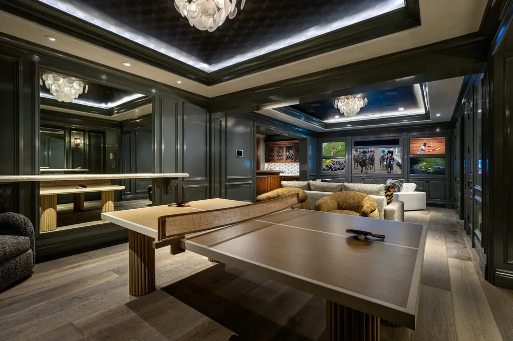 $38,500,000 Shady Canyon Estate in Irvine Blends Contemporary European Design With Nearly an Acre of Privacy 9 Luxury entertainment lounge at 76 Golden Eagle in Shady Canyon featuring table tennis, custom bar, media wall, and designer finishes