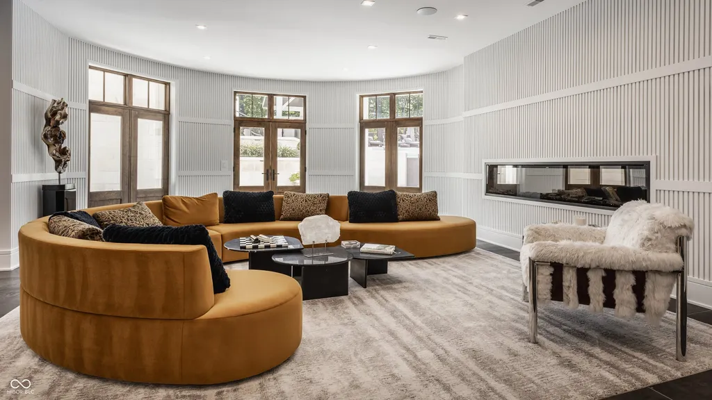 Newly Built $11.9 Million European-Inspired Estate Debuts on 14 Wooded Acres in Carmel, Indiana 11 Contemporary conversation lounge with curved seating and linear fireplace inside the $11.9 million Carmel luxury estate