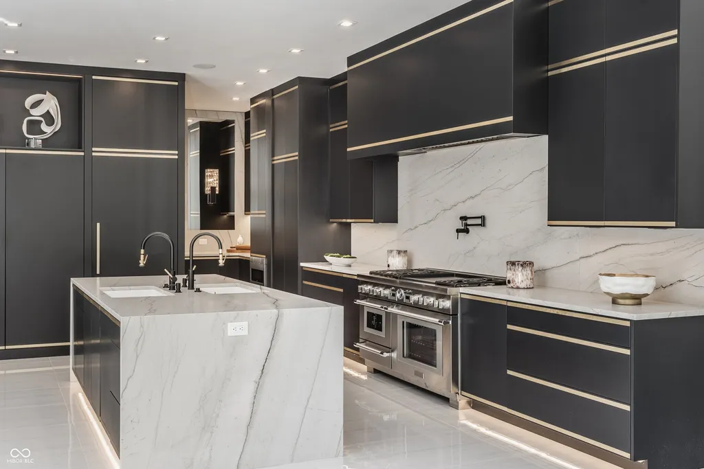 Newly Built $11.9 Million European-Inspired Estate Debuts on 14 Wooded Acres in Carmel, Indiana 5 Designer gourmet kitchen with marble waterfall island, custom cabinetry and Thermador appliances in the $11.9 million Carmel luxury estate