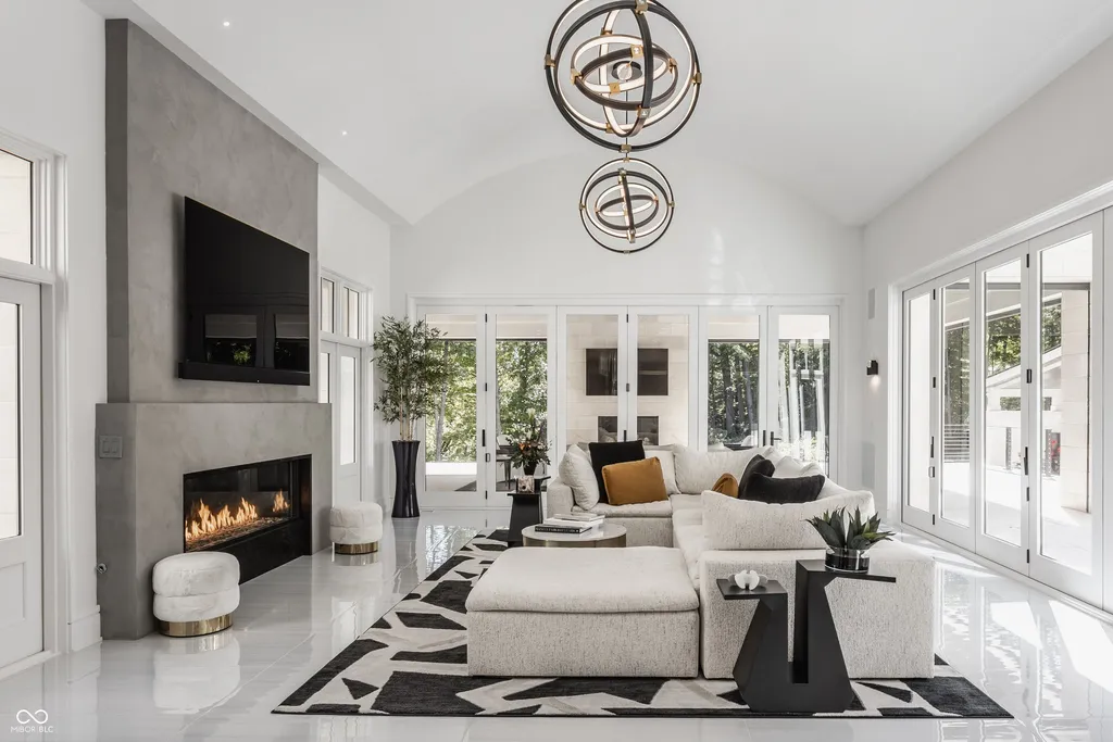 Newly Built $11.9 Million European-Inspired Estate Debuts on 14 Wooded Acres in Carmel, Indiana 4 Contemporary great room with fireplace, vaulted ceiling and floor-to-ceiling glass inside the $11.9 million Carmel luxury estate