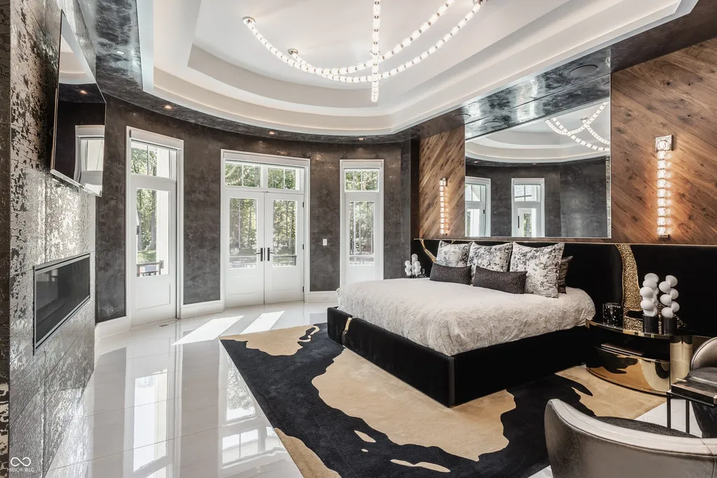 Newly Built $11.9 Million European-Inspired Estate Debuts on 14 Wooded Acres in Carmel, Indiana 8 Designer primary bedroom with contemporary finishes, fireplace and private terrace access in the $11.9 million Carmel luxury estate