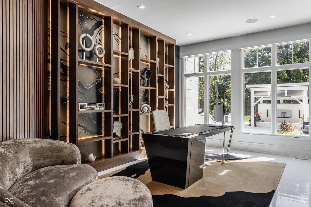 Newly Built $11.9 Million European-Inspired Estate Debuts on 14 Wooded Acres in Carmel, Indiana 10 Contemporary executive home office with custom illuminated shelving and floor-to-ceiling windows in the $11.9 million Carmel luxury estate