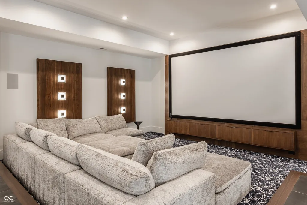 Newly Built $11.9 Million European-Inspired Estate Debuts on 14 Wooded Acres in Carmel, Indiana 12 Private home theater with oversized projection screen and luxury sectional seating inside the $11.9 million Carmel luxury estate